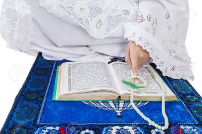 A Pregnant Woman Praying While Sitting