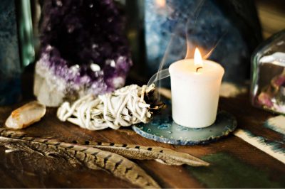 amethyst candle feathers and sage