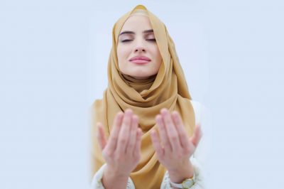 muslim woman with hijab making prayer