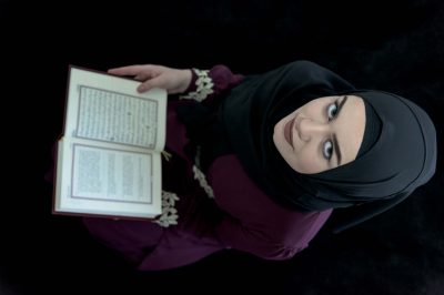 young Muslim woman, reciting the Qur'an