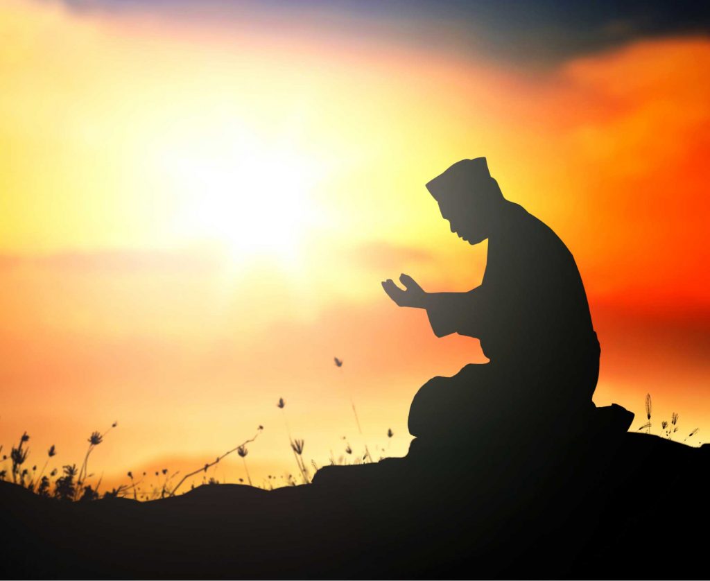 Repent concept: Silhouette Muslim man sitting and praying